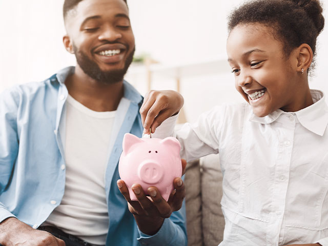 Parent talking to child about savings
