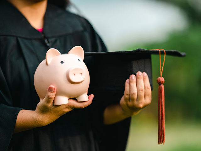 Student holding piggy bank