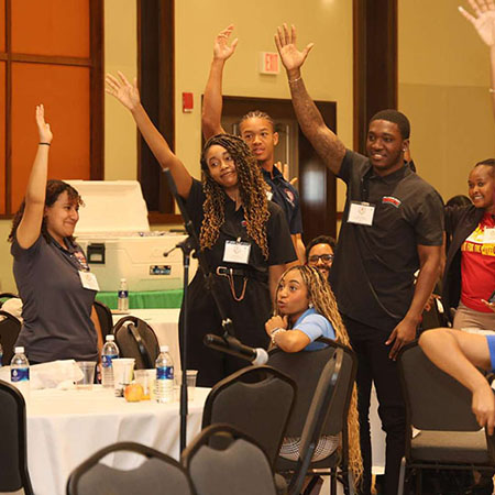 students raising hands